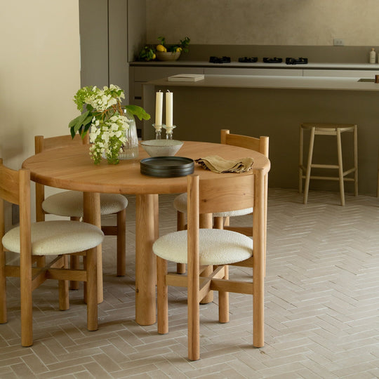Round Topa Topa dining table in warm white oak set for a holiday dinner