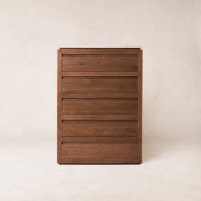 Close-up front view of the wooden five-drawer dresser showing uniform shallow drawer fronts and integrated handles.